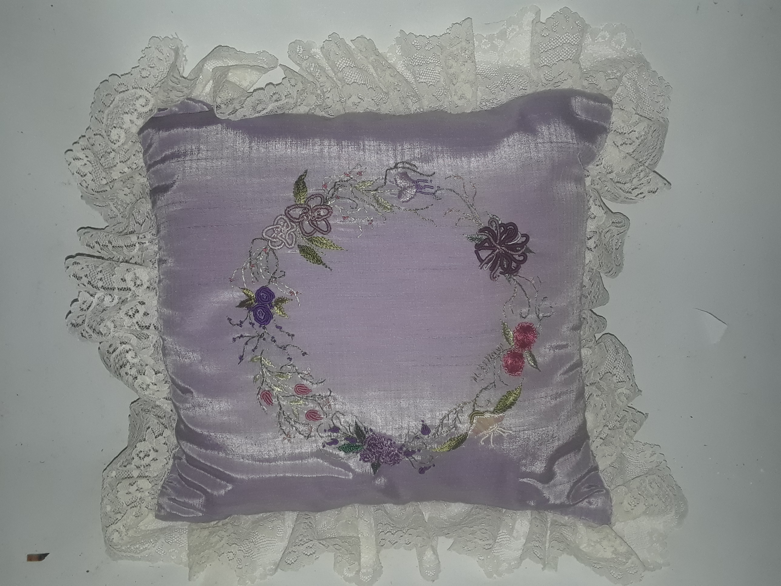 Purple decorative pillow with floral design