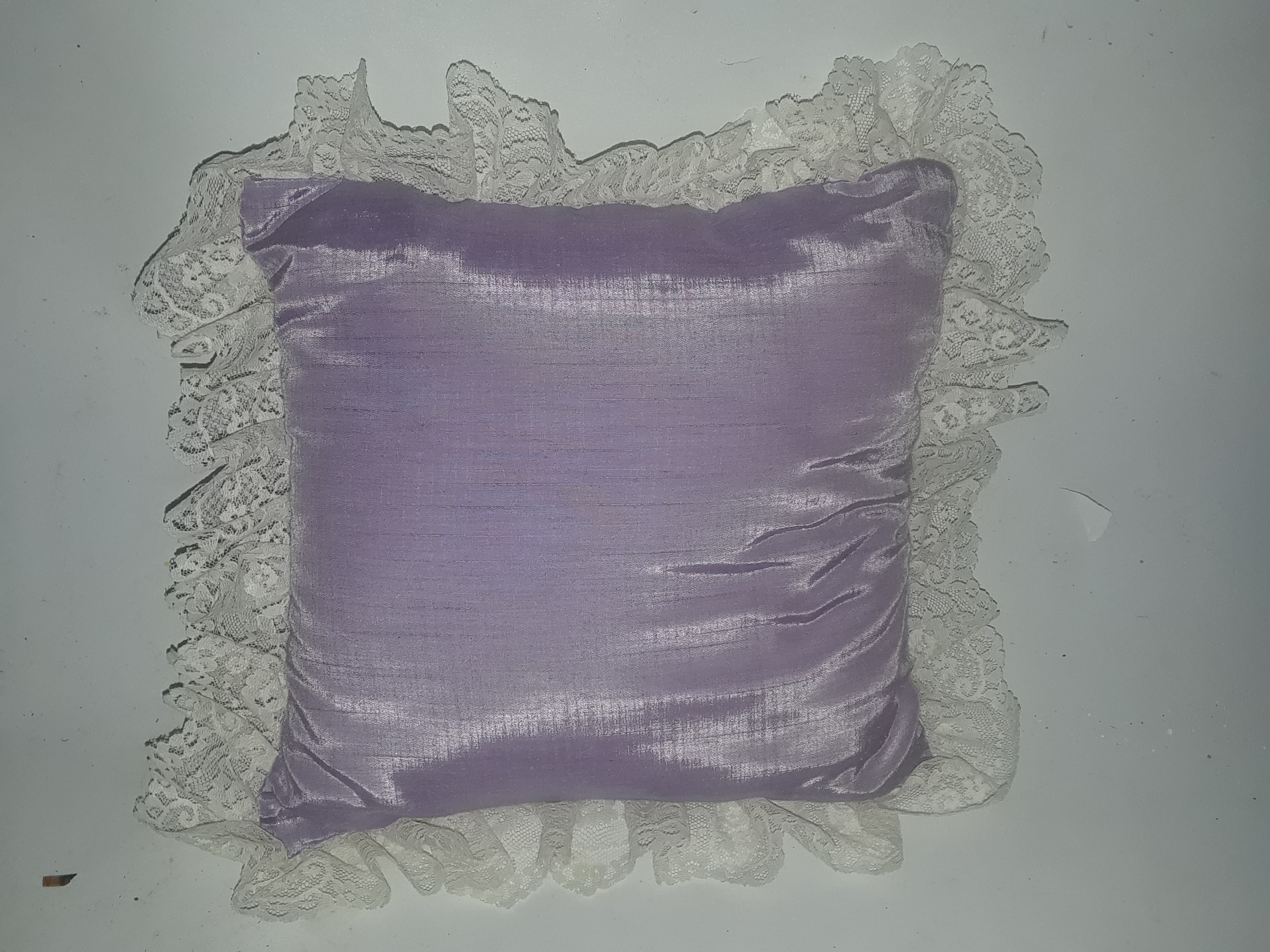 Purple decorative pillow with floral design